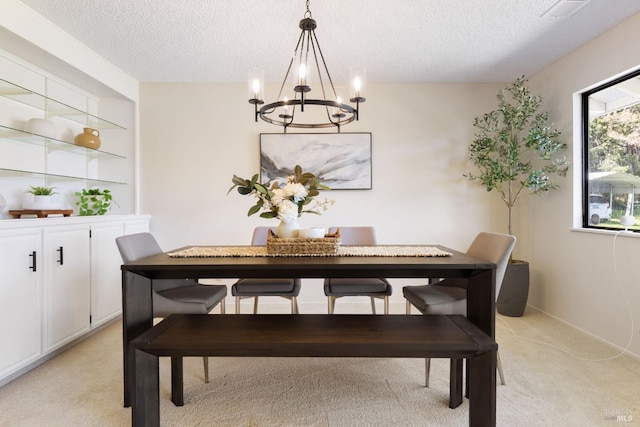 dining space featuring visible vents, an inviting chandelier, light carpet, and a textured ceiling