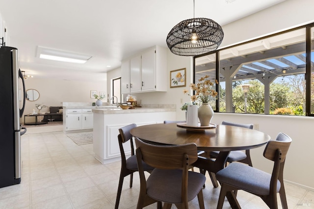 dining area featuring an inviting chandelier and baseboards