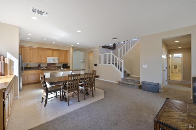 dining room with recessed lighting, arched walkways, visible vents, and stairs