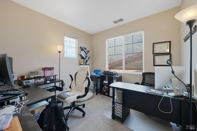 office area with visible vents and carpet flooring