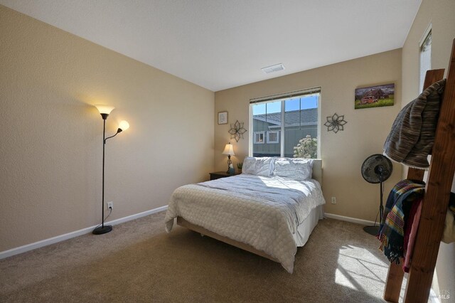 bedroom with baseboards, visible vents, and carpet floors