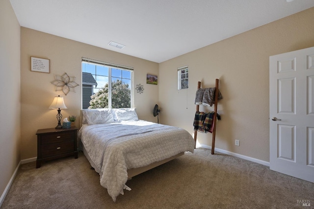 carpeted bedroom featuring visible vents and baseboards