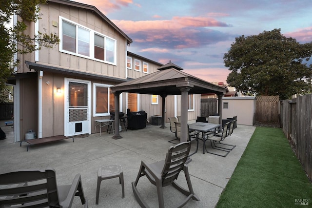 view of patio with a fenced backyard, a gazebo, and outdoor dining space