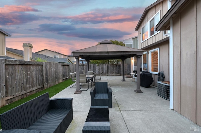 view of patio featuring central AC, a gazebo, outdoor lounge area, a fenced backyard, and outdoor dining area