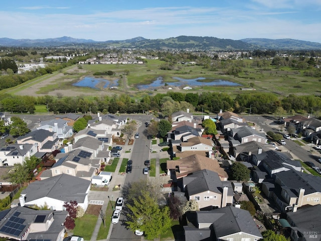 aerial view with a water and mountain view and a residential view
