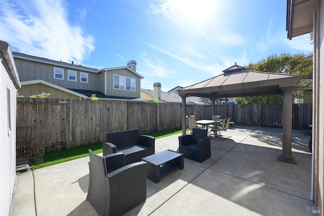 view of patio featuring an outdoor living space, a gazebo, a fenced backyard, and outdoor dining area
