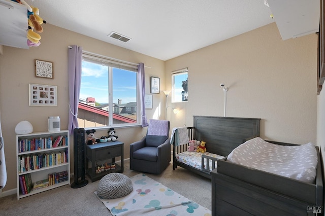 carpeted bedroom with visible vents and baseboards