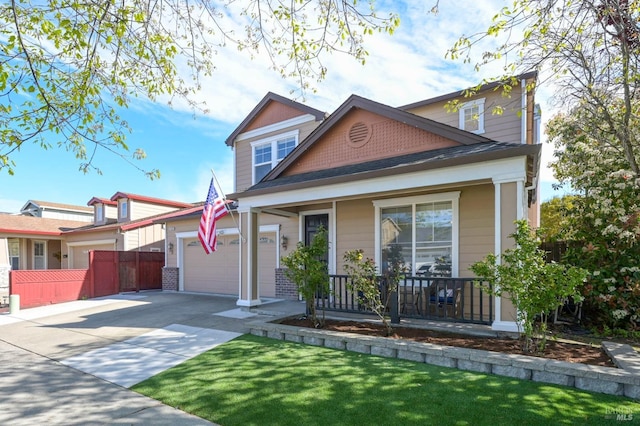 view of front of house featuring concrete driveway, a front lawn, a porch, a garage, and fence