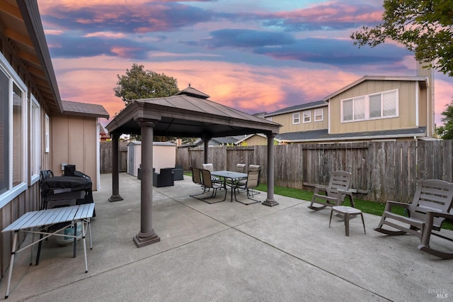 view of patio / terrace with a gazebo, a fenced backyard, and outdoor dining space