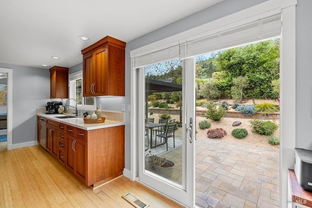 interior space featuring recessed lighting, light countertops, dishwasher, visible vents, and a sink