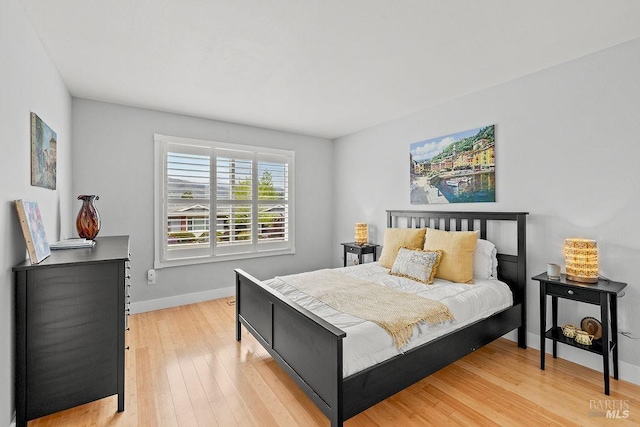 bedroom featuring light wood-type flooring and baseboards