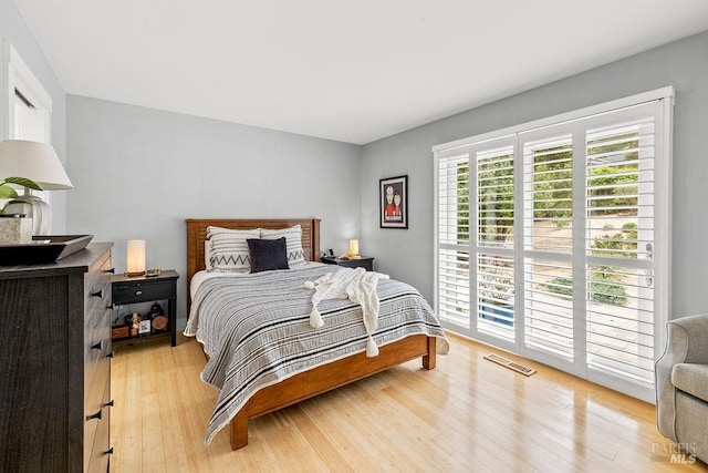 bedroom featuring visible vents and light wood-style floors