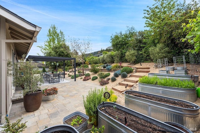 exterior space with a garden and outdoor dining area