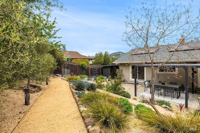 exterior space featuring solar panels, a patio, and fence