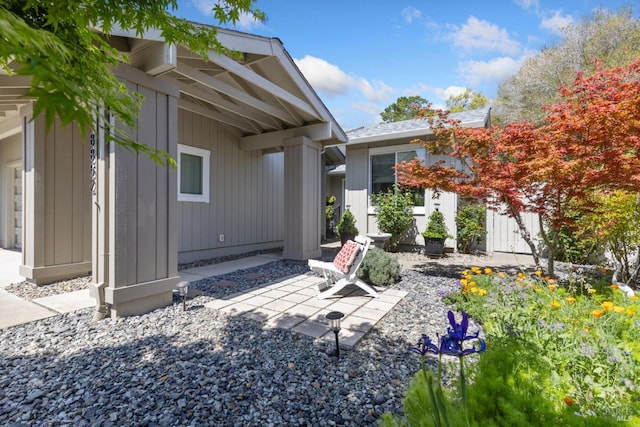 exterior space featuring board and batten siding and a patio area
