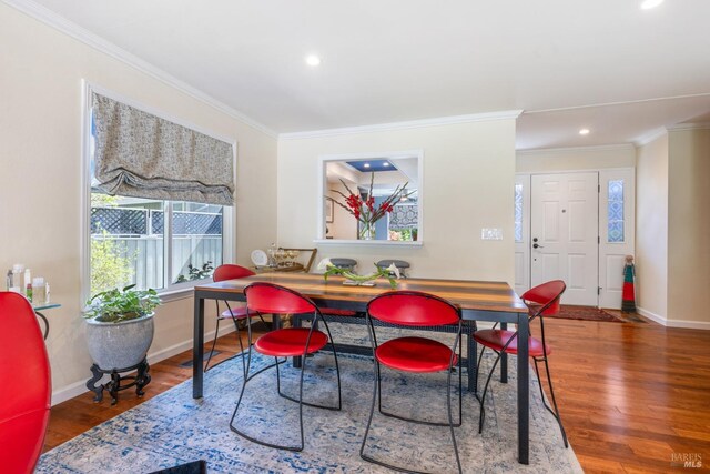 dining room featuring crown molding, baseboards, recessed lighting, and wood finished floors