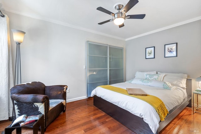 bedroom featuring crown molding, a ceiling fan, baseboards, and wood finished floors