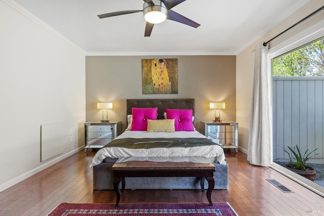 bedroom with ceiling fan, visible vents, crown molding, hardwood / wood-style flooring, and baseboards
