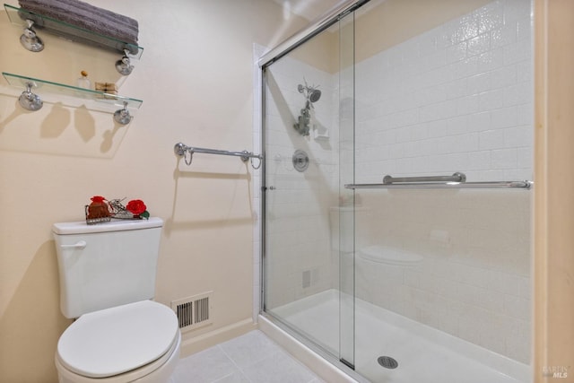 bathroom featuring visible vents, tile patterned flooring, toilet, baseboards, and a stall shower