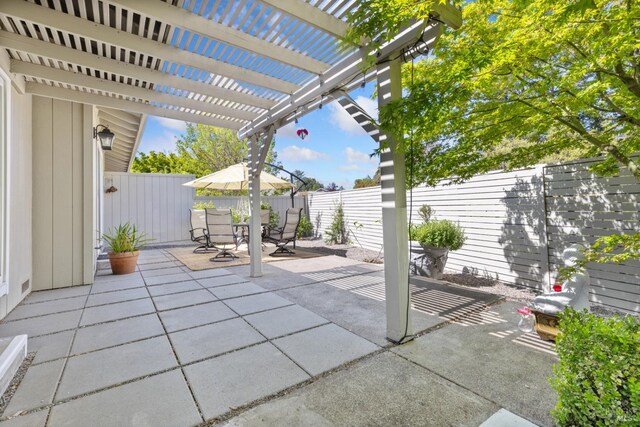 view of patio / terrace with outdoor dining area, a fenced backyard, and a pergola
