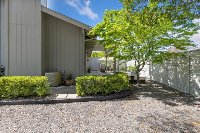 view of side of home with a patio and a fenced backyard