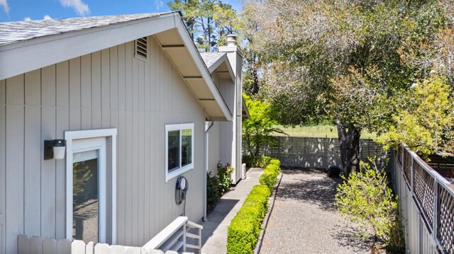 view of home's exterior featuring a fenced backyard and a chimney