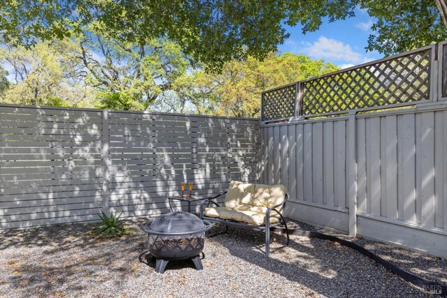 view of patio / terrace featuring an outdoor fire pit and fence