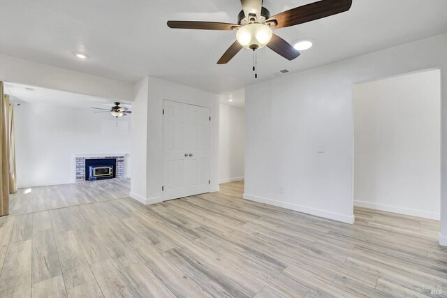 1464 Mcgregor Ave, Petaluma, CA 94954 - unfurnished living room with ceiling fan, light wood-type flooring, and a fireplace
