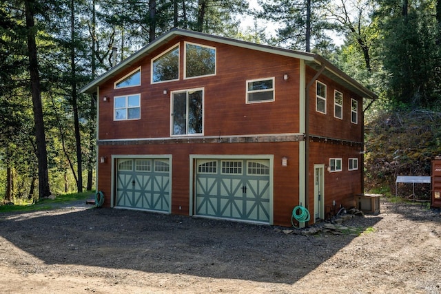 view of side of home with a garage and driveway