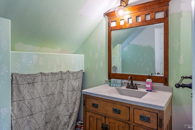 bathroom with vanity and vaulted ceiling