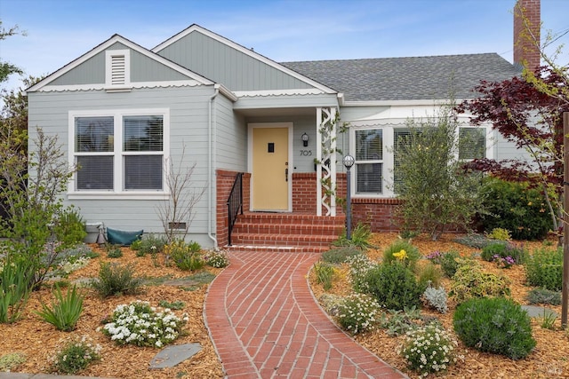705 5th St, Petaluma, CA 94952 - bungalow-style house featuring roof with shingles, board and batten siding, and a chimney