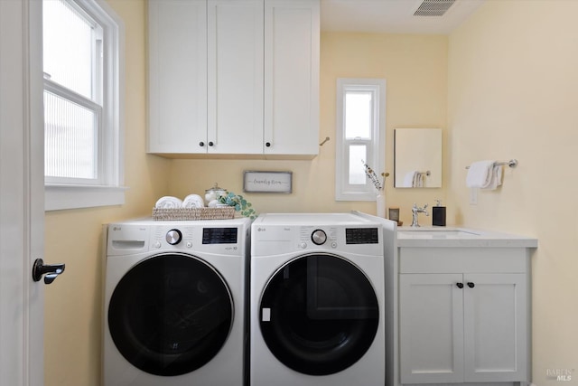 705 5th St, Petaluma, CA 94952 - laundry area with a sink, visible vents, washer and clothes dryer, and a healthy amount of sunlight