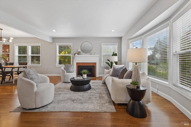 705 5th St, Petaluma, CA 94952 - living area with a healthy amount of sunlight, an inviting chandelier, a fireplace, and baseboards