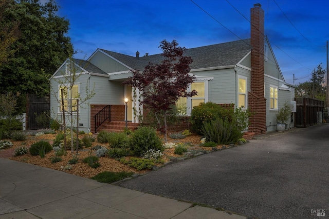 705 5th St, Petaluma, CA 94952 - view of front facade with fence, a shingled roof, and a chimney