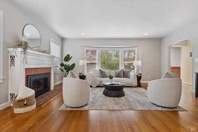 705 5th St, Petaluma, CA 94952 - living room featuring recessed lighting, arched walkways, a brick fireplace, and wood finished floors