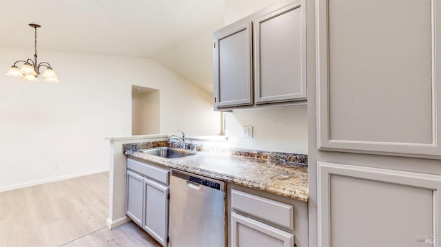 kitchen with stainless steel dishwasher, a sink, lofted ceiling, hanging light fixtures, and light wood finished floors