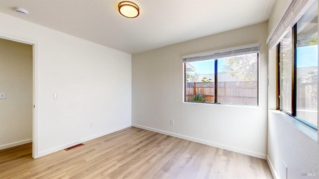 unfurnished room with visible vents, baseboards, and light wood-style floors
