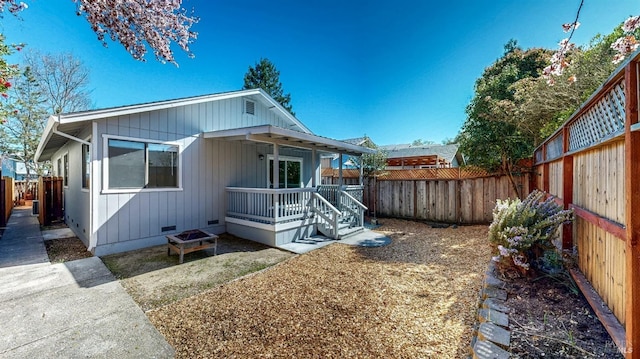 rear view of property with a fenced backyard