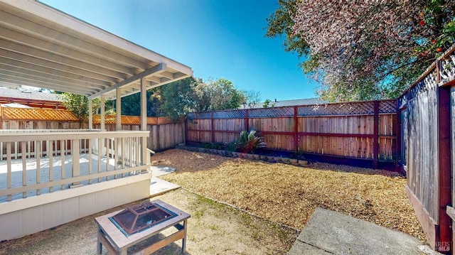 view of yard featuring an outdoor fire pit and a fenced backyard