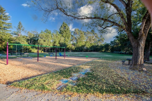 surrounding community with playground community and a lawn