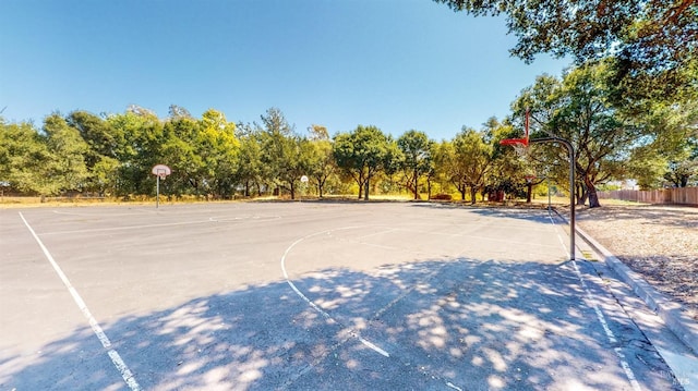 view of basketball court featuring community basketball court and fence