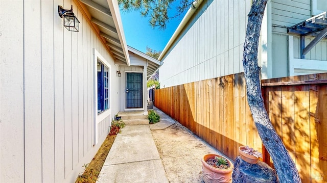 view of side of property featuring fence
