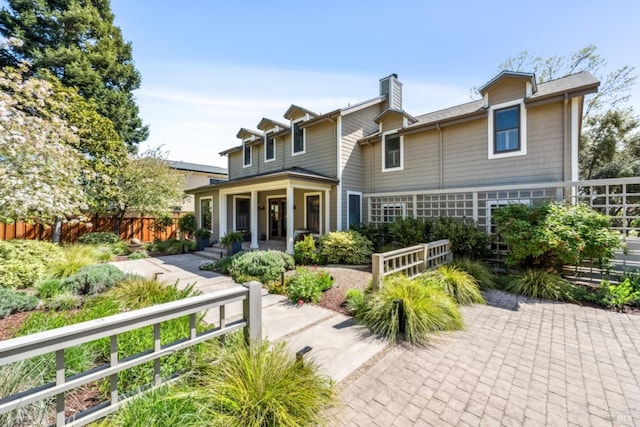 999 Pratt Ave, Saint Helena, CA 94574 - rear view of house featuring a fenced front yard, a chimney, and covered porch