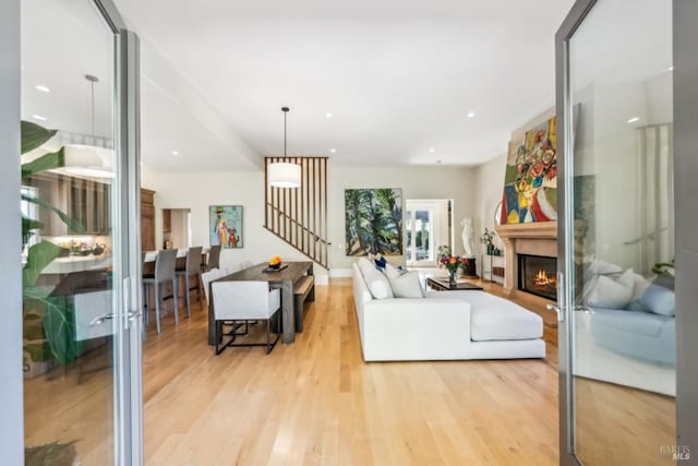 999 Pratt Ave, Saint Helena, CA 94574 - living area featuring recessed lighting, a lit fireplace, wood finished floors, and stairs