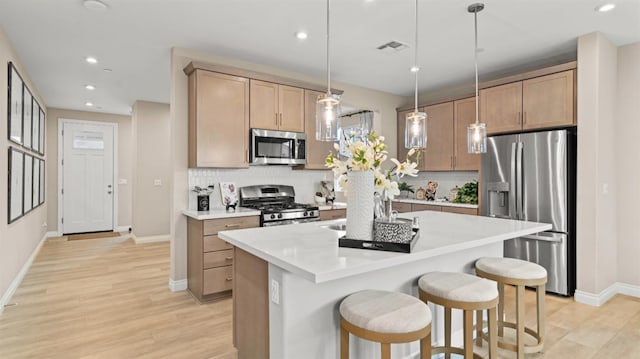3916 Valance Way, Rancho Cordova, CA 95742 - kitchen featuring appliances with stainless steel finishes, decorative backsplash, light wood-style floors, and recessed lighting