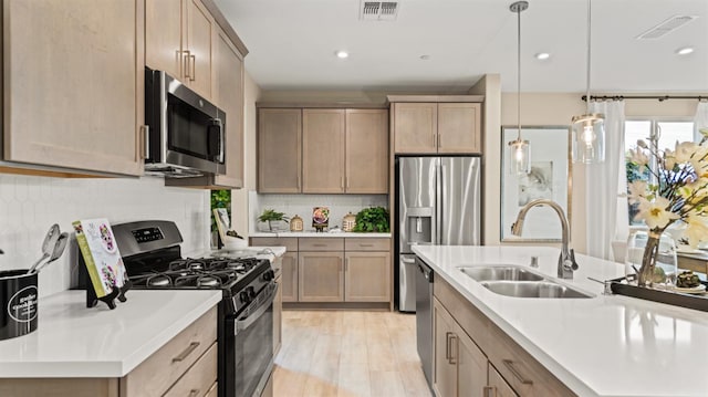 3916 Valance Way, Rancho Cordova, CA 95742 - kitchen with stainless steel appliances, a sink, light countertops, decorative light fixtures, and recessed lighting
