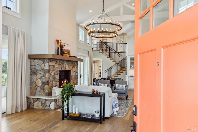9123 Red Hill Ct, Cotati, CA 94931 - living area featuring high vaulted ceiling, stairway, wood-type flooring, a chandelier, and a fireplace
