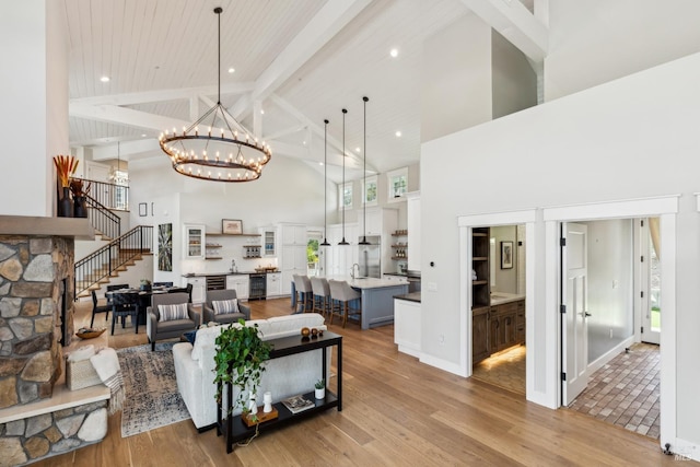 9123 Red Hill Ct, Cotati, CA 94931 - living room with high vaulted ceiling, beam ceiling, a chandelier, light wood finished floors, and stairs