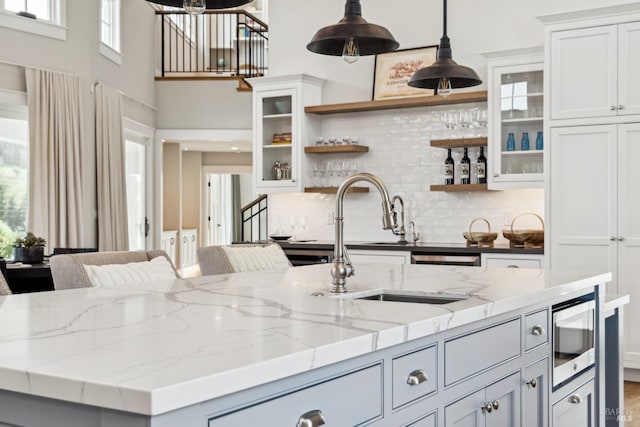 9123 Red Hill Ct, Cotati, CA 94931 - kitchen with open shelves, backsplash, decorative light fixtures, stainless steel microwave, and white cabinets