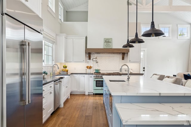 9123 Red Hill Ct, Cotati, CA 94931 - kitchen with premium appliances, high vaulted ceiling, white cabinets, hardwood / wood-style flooring, and backsplash